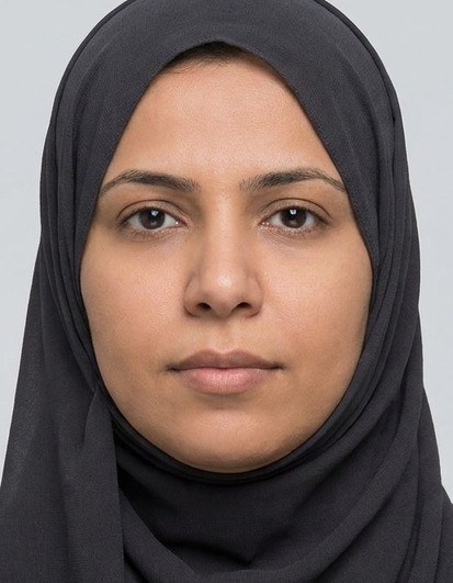 Biometrically cropped ID photo of a woman wearing a headscarf.